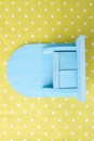 Small mini blue cupboard on a dotted yellow background. Royalty Free Stock Photo