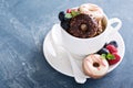 Small mini donuts in stacked coffee cups