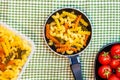 Small mini frying pan with tricolor raw fusilli pasta in a rustic composition Royalty Free Stock Photo