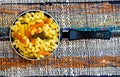 Small mini frying pan with tricolor raw fusilli pasta in a rustic composition Royalty Free Stock Photo