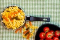 Small mini frying pan with tricolor raw fusilli pasta in a rustic composition Royalty Free Stock Photo