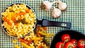 Small mini frying pan with tricolor raw fusilli pasta in a rustic composition Royalty Free Stock Photo