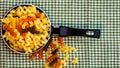Small mini frying pan with tricolor raw fusilli pasta in a rustic composition Royalty Free Stock Photo