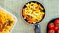 Small mini frying pan with tricolor raw fusilli pasta in a rustic composition Royalty Free Stock Photo