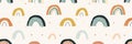 Small, minimalist rainbows in muted tones, repeated in a cute pattern on a white background Royalty Free Stock Photo