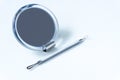 Small mirror and cosmetic tool for removing acne. Royalty Free Stock Photo