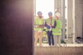 Small mixed group of young architects meeting and discussing on a construction site