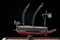 A small model of Korean ironclad war ship. Korean turtle ship on a black background. Black and white and red