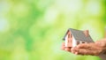 small model house with green bokeh background Royalty Free Stock Photo