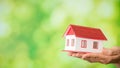 small model house with green bokeh background Royalty Free Stock Photo