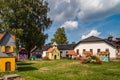 Small models of half-timbered Alsatian houses stand on a green lawn on a sunny day