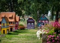 Small models of half-timbered Alsatian houses stand on a green lawn on a sunny day