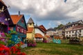 Small models of half-timbered Alsatian houses stand on a green lawn on a sunny day