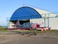 Small modern airplane near hangar