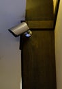 Small modern CCTV is installed on the wooden pillar