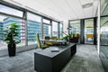 Small modern office boardroom and meeting room interior with desks, chairs and cityscape view