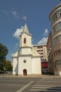 Small modest evangelic church in between modern apartment buildings Alba Iulia, Romania