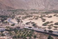 Small mosque in the rural area of Musandam province Suburbs of Bukha village, Oman. Palm trees in the desert under steep Royalty Free Stock Photo