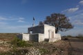 A small mosque and a tree