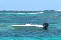 small motor boat sailing on the big turquoise ocean with waves.