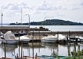 Small motor boats moored on wooden poles of the pier of a small port in Lake Trasimeno Umbria, Italy Royalty Free Stock Photo