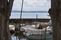 Small motor boats moored on wooden poles of the pier of a small port in Lake Trasimeno Umbria, Italy Royalty Free Stock Photo