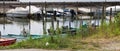 Small motor boats moored on wooden poles of the pier of a small port in Lake Trasimeno Umbria, Italy Royalty Free Stock Photo