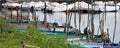 Small motor boats moored on wooden poles of the pier of a small port in Lake Trasimeno Umbria, Italy Royalty Free Stock Photo