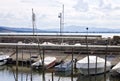 Small motor boats moored on wooden poles of the pier of a small port in Lake Trasimeno Umbria, Italy Royalty Free Stock Photo