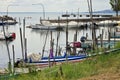 Small motor boats moored on wooden poles of the pier of a small port in Lake Trasimeno Umbria, Italy Royalty Free Stock Photo