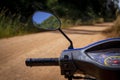 Small motorbike or scooter dashboard with dirt track leading into nature