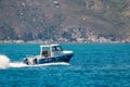 Small motorboat cruising in Hout Bay, Cape Town