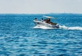 Small Motorboat with a Family on Board in motion on Lake Garda - Italy Royalty Free Stock Photo