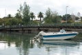 Small motorboat moored in the river crossing the city