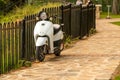 Small motorcycle parked by the fence Royalty Free Stock Photo