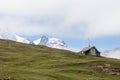 A small mountain chapel with snow mountain