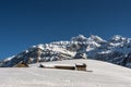 Small mountain huts on an alp in front of the Saentis massif in winter, Canton Appenzell-Ausserrhoden, Switzerland Royalty Free Stock Photo