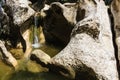 Small mountain river waterfall and fancy formed big grey stones Royalty Free Stock Photo