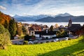 small mountain village and snowy peaks of Alps in the background Royalty Free Stock Photo