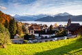 small mountain village and snowy peaks of Alps in the background Royalty Free Stock Photo