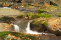 Small mountain waterfall in autumn. A beautiful landscape full of peace. Royalty Free Stock Photo