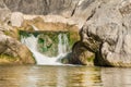 Small mountain waterfall on the rocks covered with moss deep in the forest Royalty Free Stock Photo