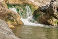 Small mountain waterfall on the rocks covered with moss deep in the forest Royalty Free Stock Photo