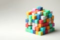 Small multi-colored cubes stacked on top of each other in a pile. Space for text. Royalty Free Stock Photo