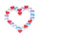 Small multicolored hearts lie in the shape of a large heart on a white background. Layout for Valentine`s Day. Isolate. View from Royalty Free Stock Photo