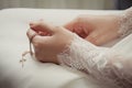 Small naive cross in the bride`s hands