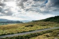 Small narrow country road in Connemara, county Galway, Ireland. Dramatic sky. Irish landscape. Beautiful nature scene Royalty Free Stock Photo