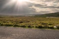 Small narrow country road in Connemara, county Galway, Ireland. Dramatic sky. Irish landscape. Beautiful nature scene Royalty Free Stock Photo