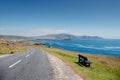 Small narrow road by the ocean, Achill Island, county Mayo, Ireland. Warm sunny day. Irish landscape. Blue clear cloudy sky. Small Royalty Free Stock Photo