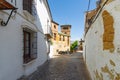 small narrow street with white houses and abundant greenery in the old European city Royalty Free Stock Photo